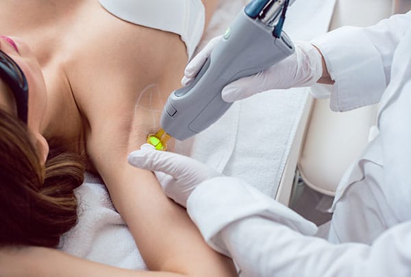 Woman during hair removal using modern laser technology